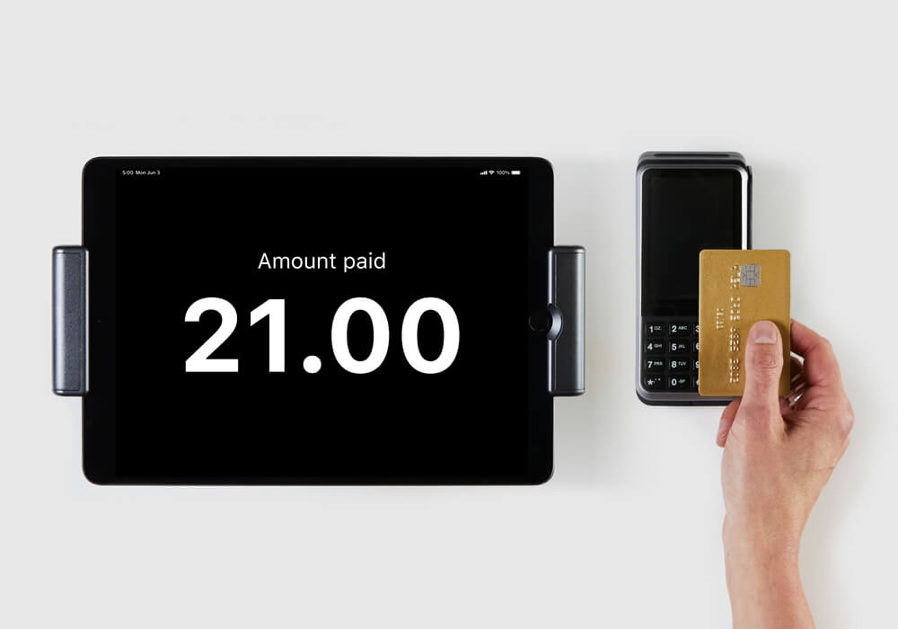hand making a payment using a payment terminal and iPad ePOS