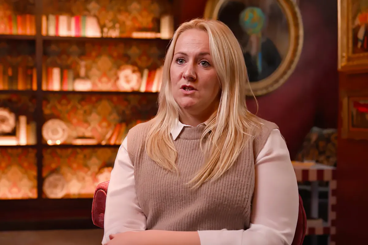 A woman at a retail store gives an interview on camera.
