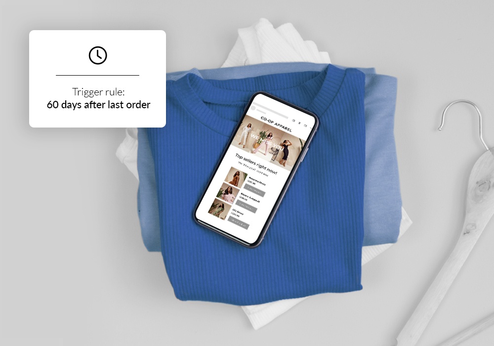 ecommerce on an iphone sitting on a pile of clothes