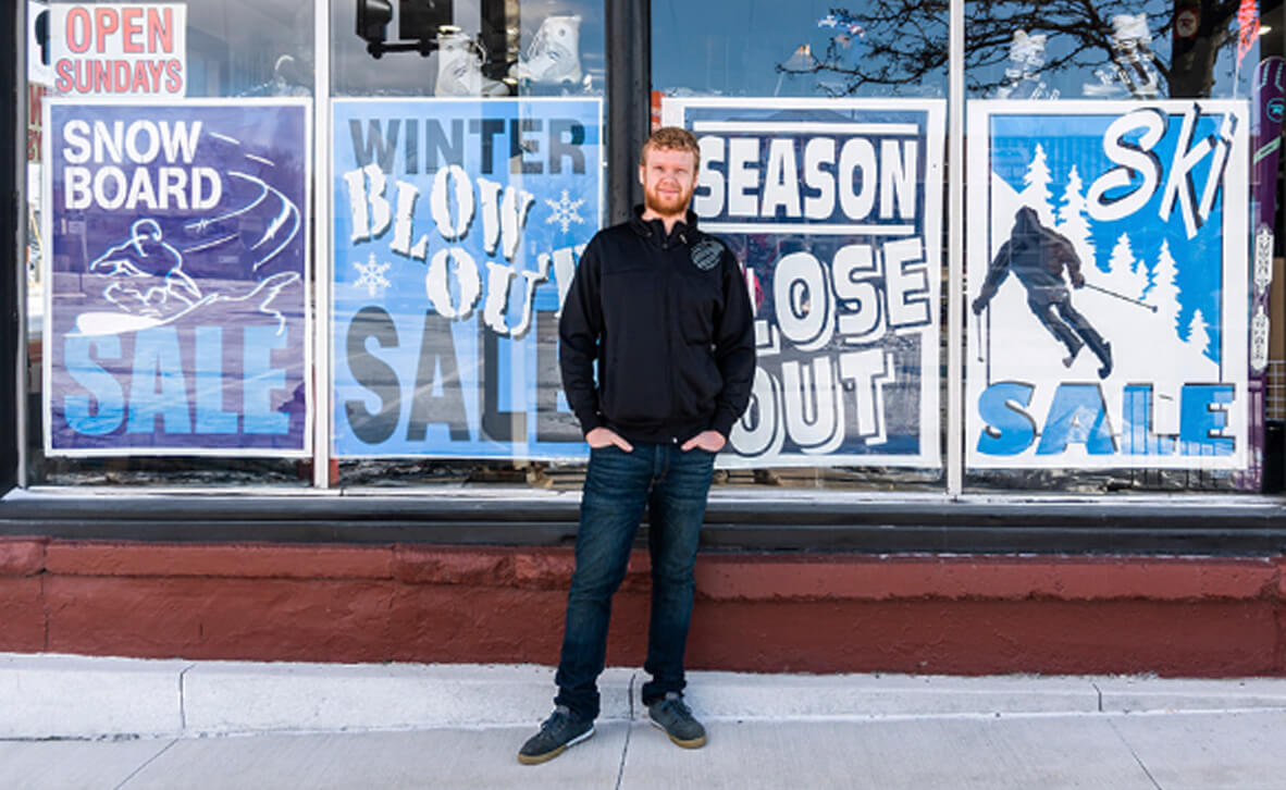 John Eppley standing in front of his family's business Alpine Cycles sporting goods store