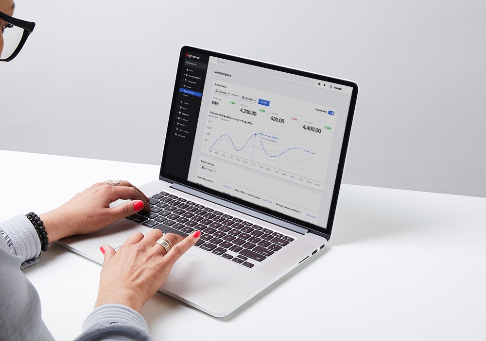 A person on a laptop tapping keys