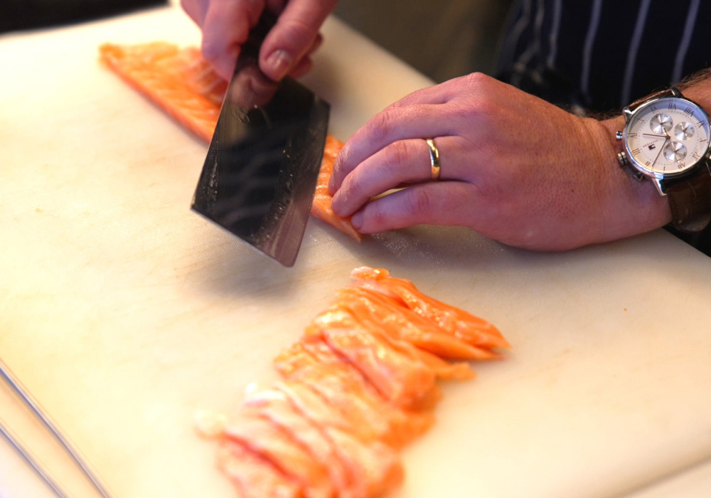Close up of slicing salmon sashimi