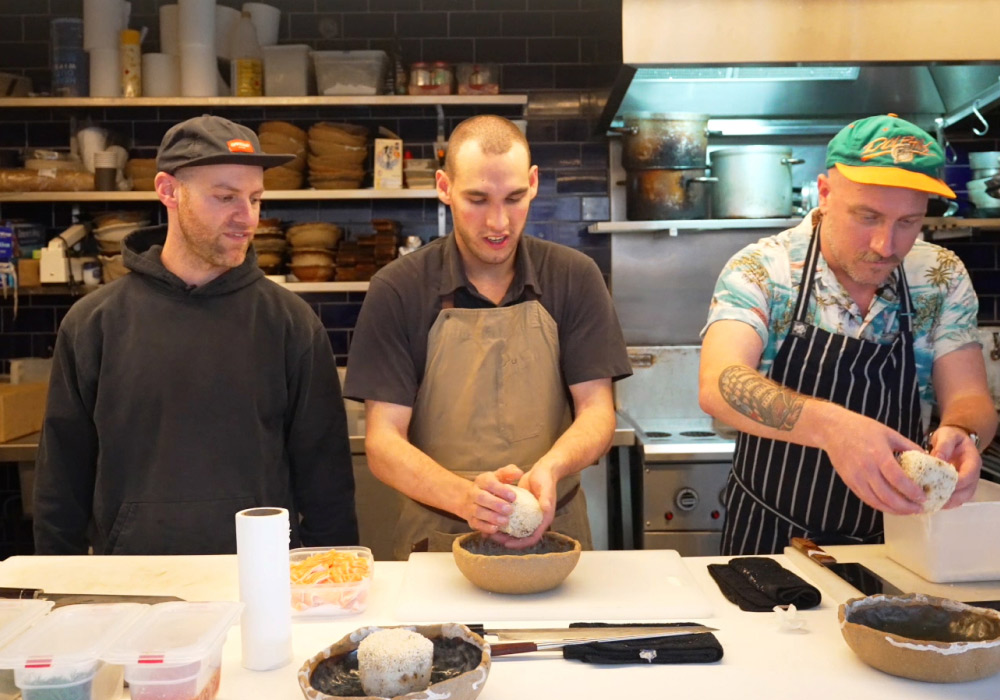 3 chefs rolling rice balls in Japanese restaurant kitchen, TenTo