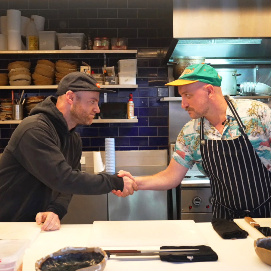 Handshake between hospitality business owner, Din Haikin, and Lightspeed employee, Graeme Alexander