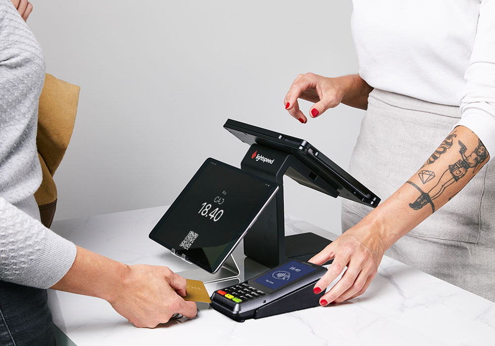person standing in front of customer-facing display