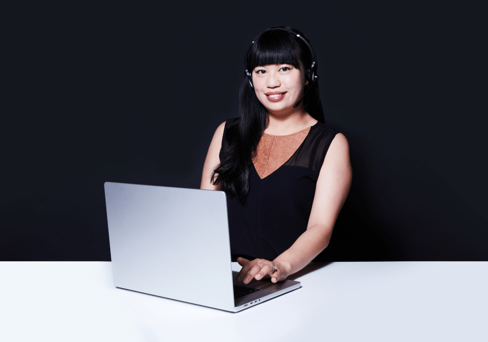 Lady in black with laptop and headset