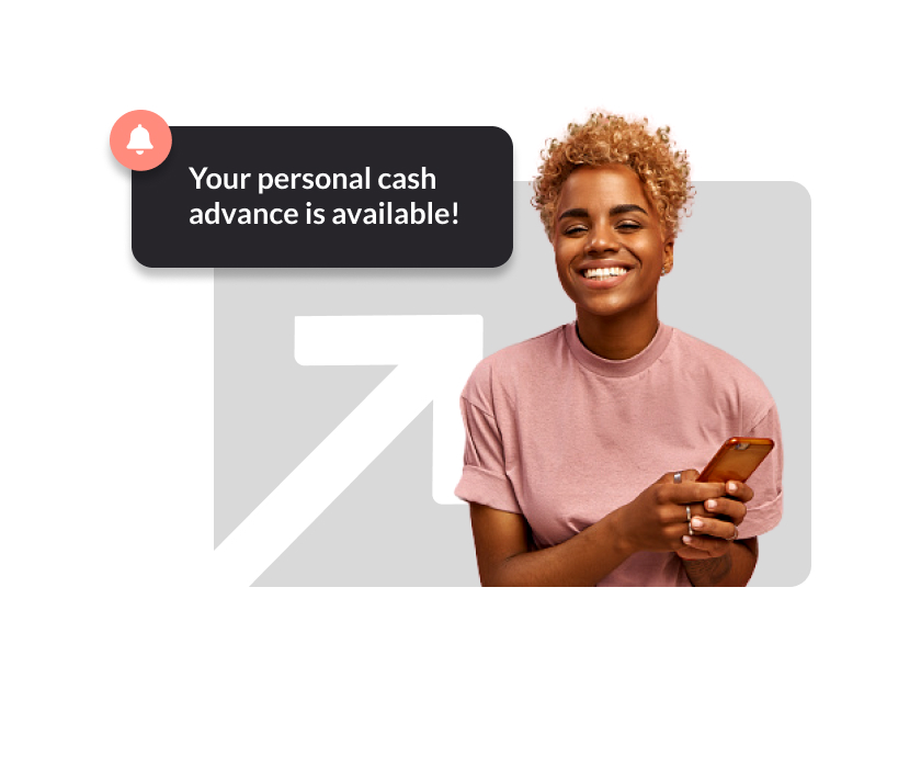 A person wearing a pink tshirt and smiling holding a phone