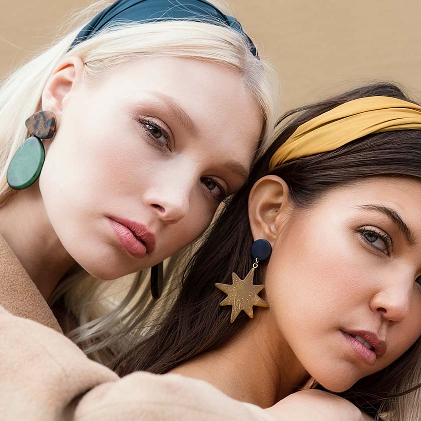 2 girls wearing headbands and earrings