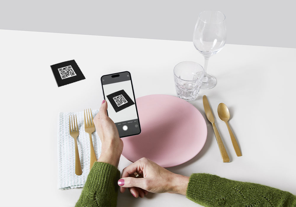 person scanning QR code on the table