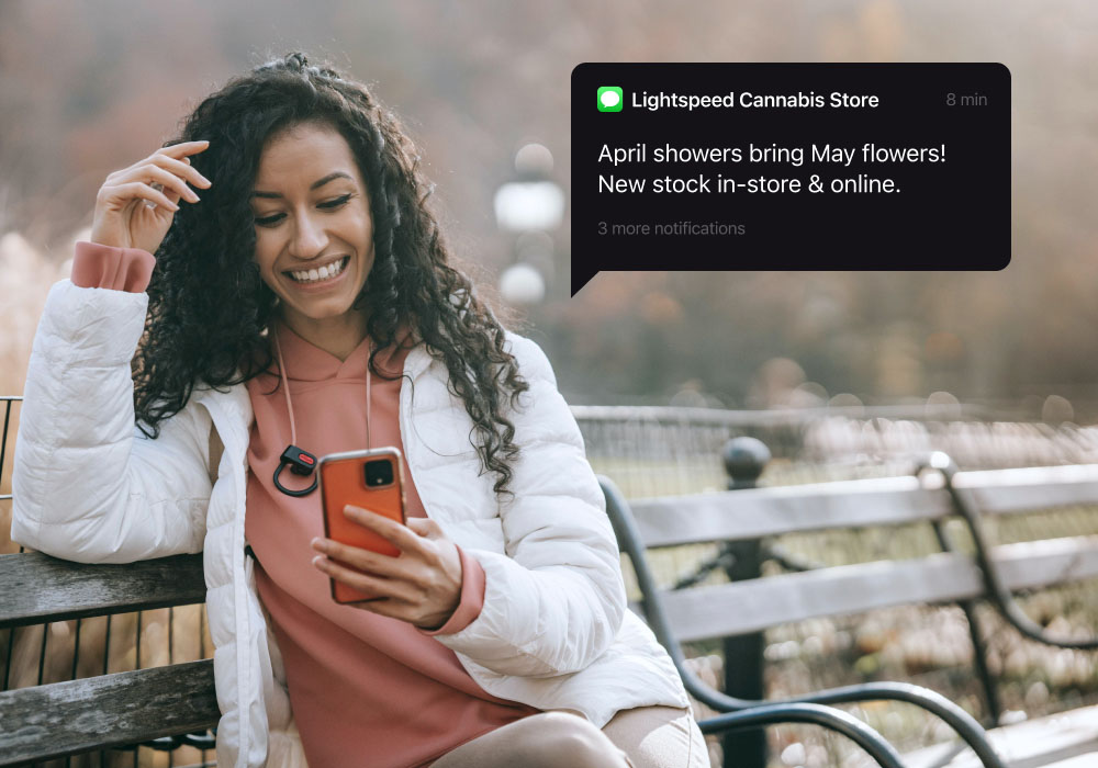 A woman receives a text from a cannabis store, sent using their marijuana POS