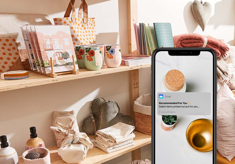 iPhone showing loyalty notification, shelves holding home decor products in background
