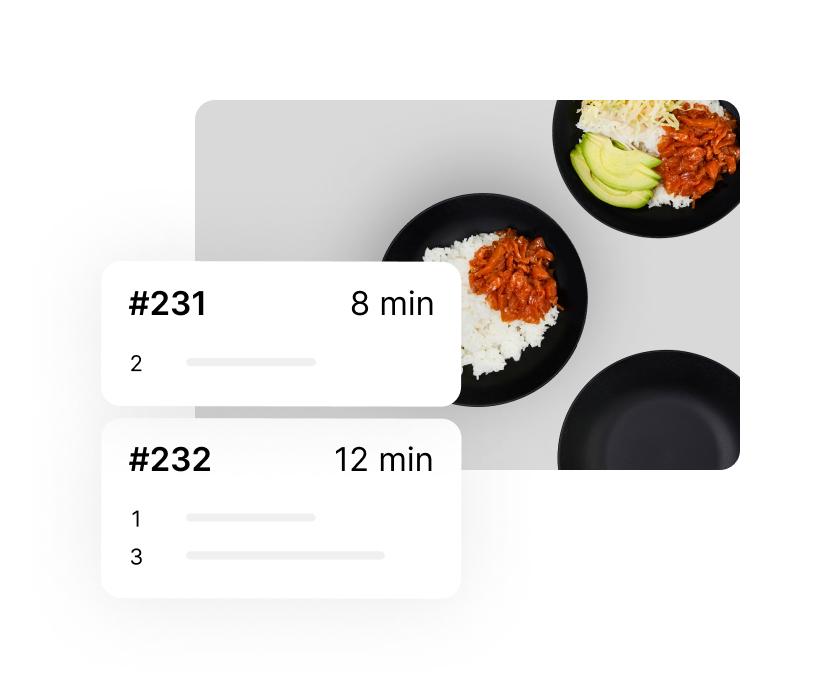 An image of two black bowls filled with rice, stew and avocado