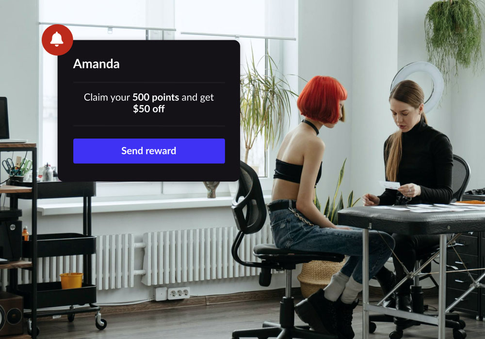 A tattoo artist and client talking with a floating module showing rewards available in Lightspeed's tattoo shop pos