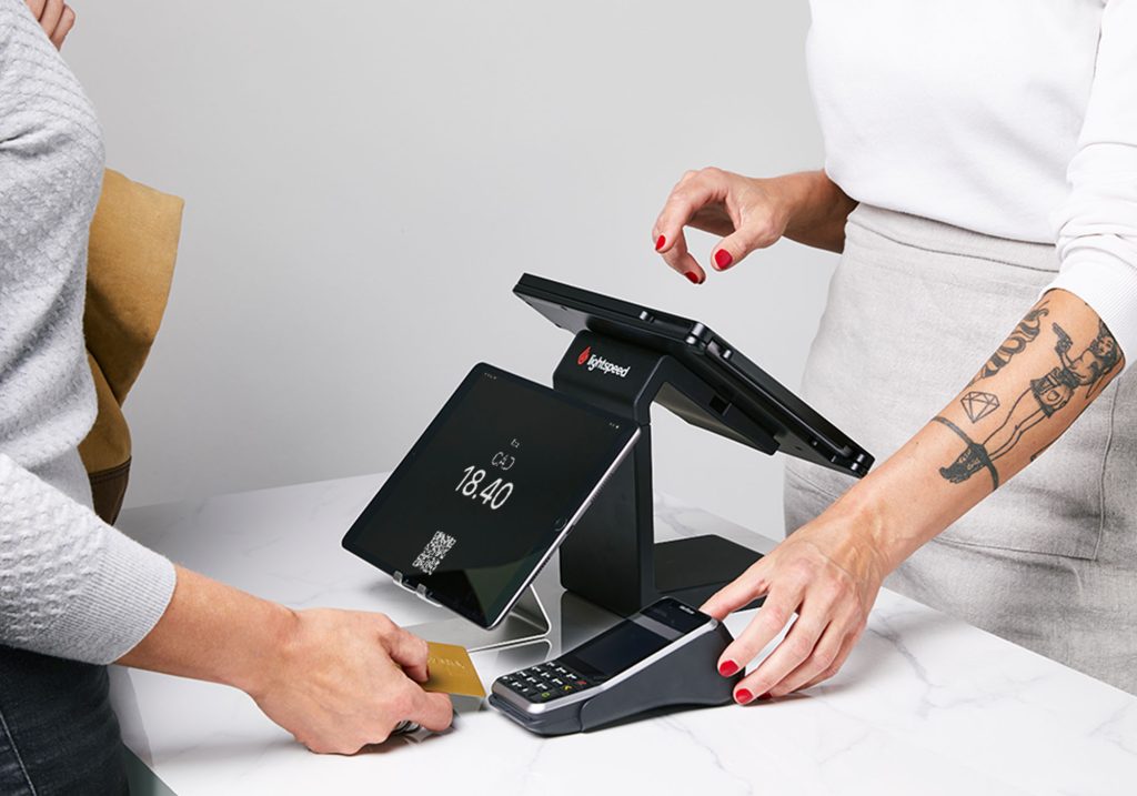A person tapping their card on a payment terminal